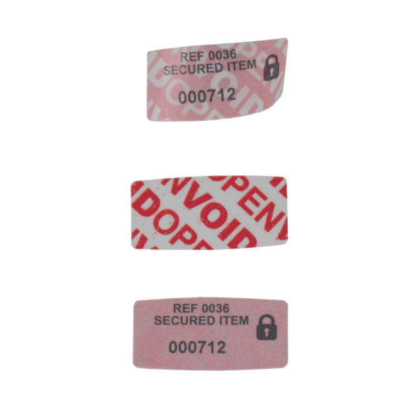 Small red permanent paper tamper evident security label hidden message