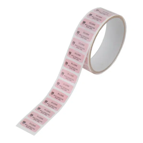 Small red permanent paper tamper evident security label on roll