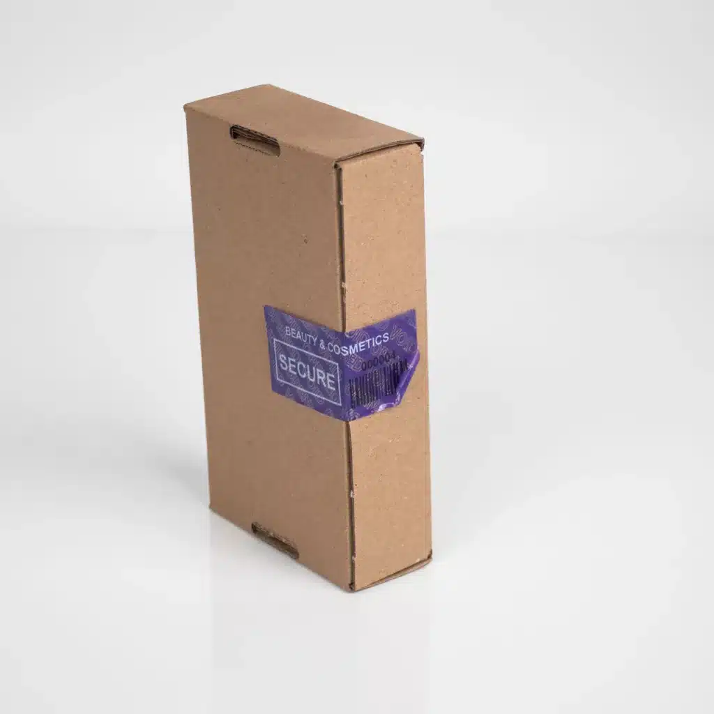 An image of a tamper-evident large label from Tampertech removed and voided for beauty and cosmetics on outer box packaging