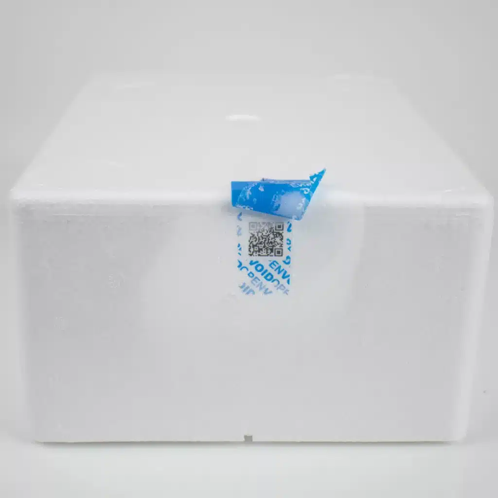Image of blue Tampertech Cold Chain Secure Labels being removed from an insulated box, showing the void message on the surface of the box after freezing.