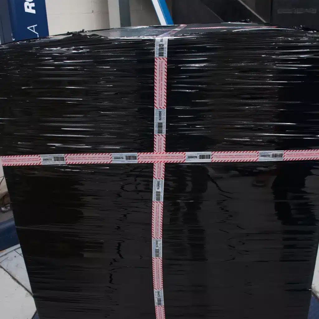 Image of Tampertech Pallet Secure Tamper Evident Security Tape applied to a pallet, demonstrating the same number and barcode per roll, per pallet.