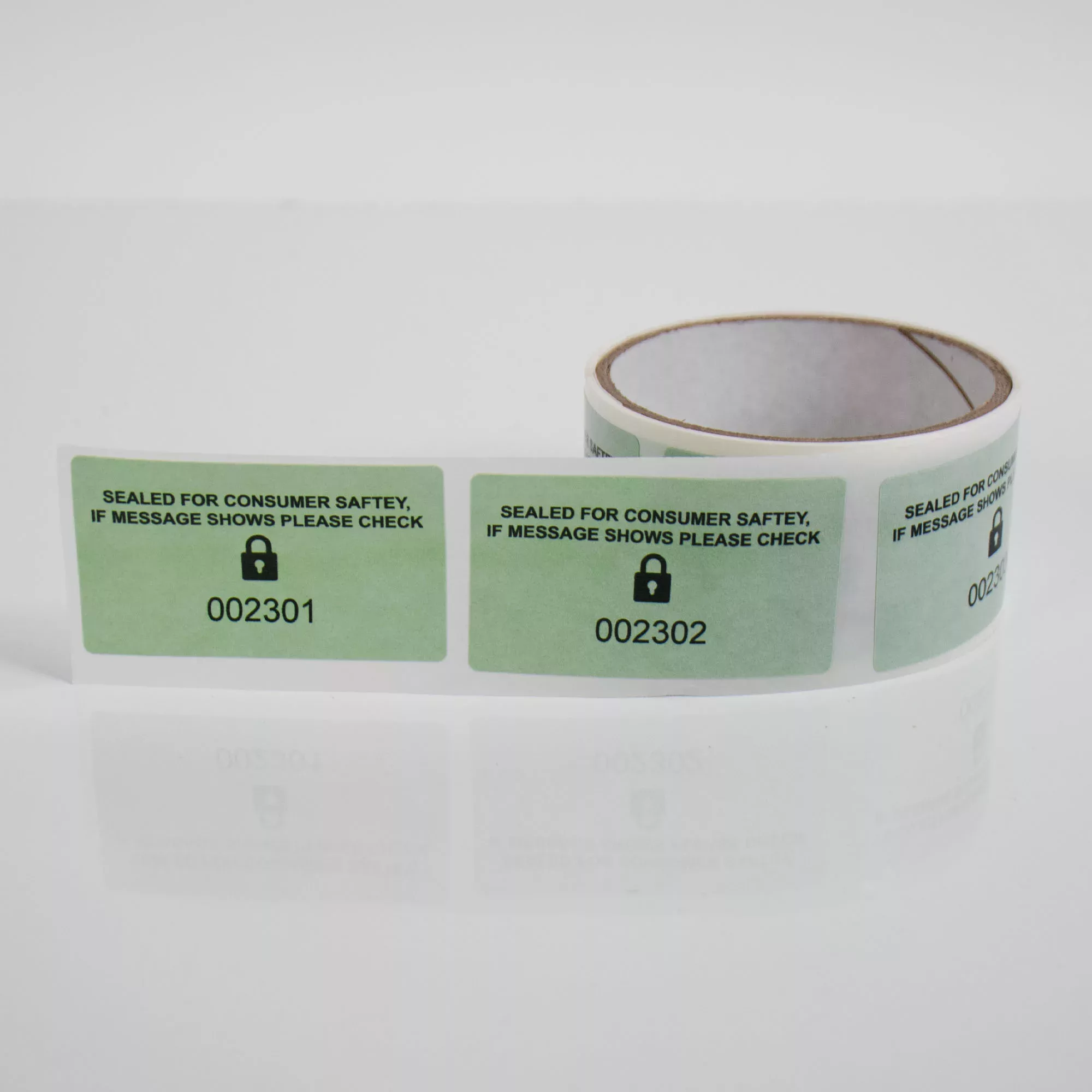Image of a roll of Secure Item permanent green paper tamper evident labels from Tampertech, 70mm x40mm, 1000 labels per roll