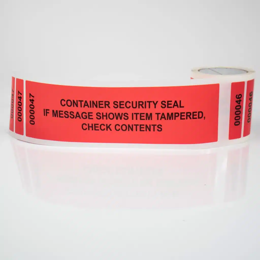 Image of a roll of tamper evident permanent Secure Container labels from Tampertech, 320mm x 90mm + 2 x 25mm x 90mm dual number tabs (DNT), 200 on a roll.