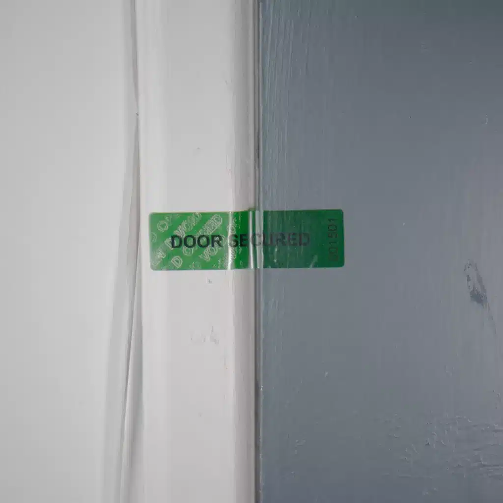 Image of a Tampertech tamper evident Door Secured secure label that has been voided, showing the void message