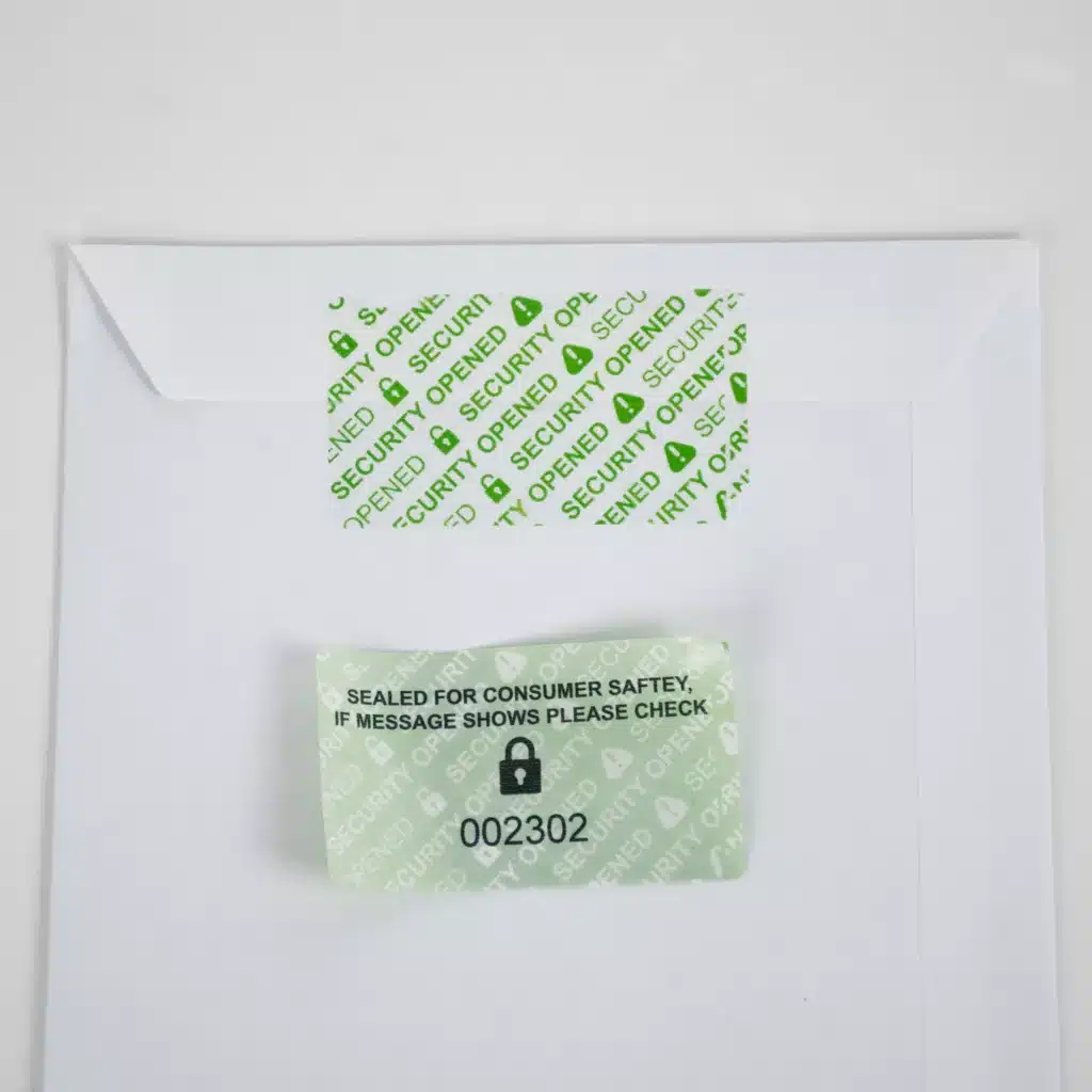 Removed Secure Item Permanent Green Tamper-Evident Label on Envelope - 'SECURITY OPENED' Void Message with a unique identifier sequential number