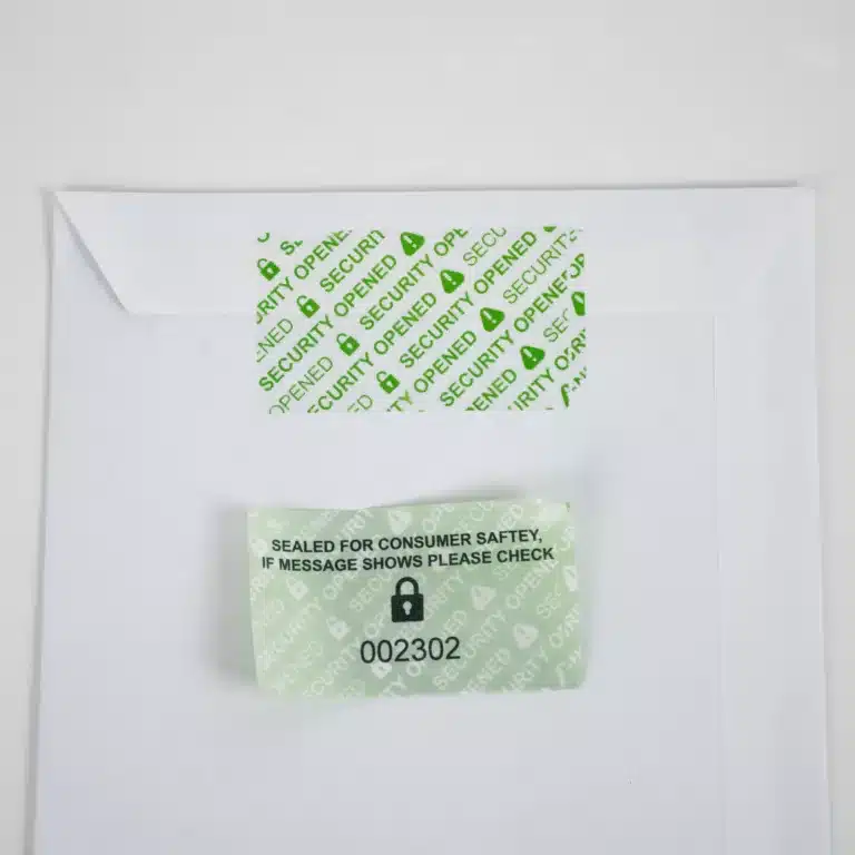 Removed Secure Item Permanent Green Tamper-Evident Label on Envelope - 'SECURITY OPENED' Void Message with a unique identifier sequential number